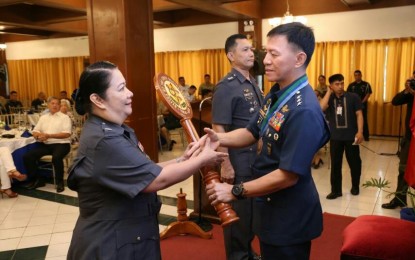 <p><strong>NEW OCDTS CHIEF.</strong> Col. Angelica de Lara-Torres (left) receives the symbol of the Office of the Chief Dental Service of the AFP from deputy chief-of-staff, Lt. Gen. Erickson Gloria (right) in a ceremony in Camp Aguinaldo, Quezon City on Wednesday (Feb. 26, 2020). She is the wife of retired Brig. Gen. Reynaldo Torres who served as OTCDS chief from 2007 to 2014. <em>(Photo courtesy of AFP Public Affairs Office)</em></p>