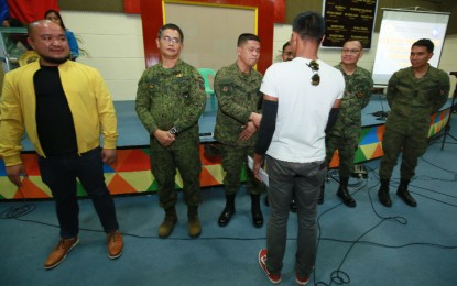 <p><strong>AID FOR REBEL RETURNEES.</strong> Davao de Oro Governor Jayvee Tyron Uy (extreme left) and military officials distribute financial assistance to 58 former communist rebels on Wednesday (Feb. 26, 2020).  Done under the government's Enhanced Comprehensive Local Integration Program, each rebel returnee received checks ranging from PHP15,000 to PHP150,000. <em>(Photo courtesy of Davao de Oro PIO)</em></p>