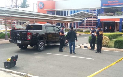 <p><strong>MONDAY MORNING AMBUSH.</strong> Scene of the crime operatives inspect the vehicle of Engr. Nicomedes Parilla Jr., the district engineer of the Department of Public Works and Highways in Davao del Sur, following an ambush that injured him and his driver in on Monday morning (March 2, 2020) in Digos City. Authorities say a pursuit operation is ongoing against the two gunmen. <em>(PNA photo by Eldie S. Aguirre)</em></p>