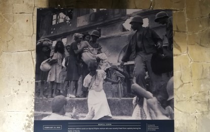 <p><strong>'BAYANIHAN'.</strong> One of the photos on exhibit at Fort Santiago in Intramuros. The photo depicts "Bayanihan" or community spirit even among American soldiers seen guiding civilians to safety and assisting the wounded held captive by the Japanese. <em>(PNA photo by Joyce Ann Rocamora)</em></p>