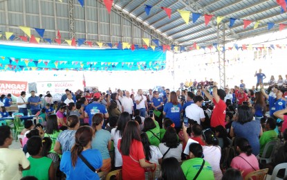 <p><strong>ASSISTANCE</strong>. Bulacan Gov. Daniel Fernando (center, holding microphone) delivers his message to the people affected by the eruption of Taal Volcano at the covered court of the Armed Forces of the Philippines (AFP) housing project in Barangay Talaibon, Ibaan, Batangas on Wednesday (Mar. 4, 2020). The AFP housing project serves as evacuation center for the displaced families. <em>(PNA photo by Manny Balbin)</em></p>