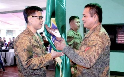 <p><strong>CHANGE OF COMMAND.</strong> Brigadier General Gene Ponio (right), passes the unit color to Lt. Colonel Jo-arr Herrera (left), in a change of command ceremony at the headquarters of the 53rd Infantry Battalion, Philippine Army, in Guipos, Zamboanga del Sur on Thursday afternoon (March 5, 2020). Lt. Col. Marlowe Patria, the outgoing commander, is set to assume the post of the assistant chief of staff for Civil-Military Operations of the 1st Infantry Division in Labangan, Zamboanga del Sur. <em>(Photo courtesy of 1ID)</em></p>
