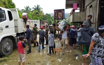 <p><strong>RETURNING HOME.</strong> Personnel of the Army's 3rd Special Forces Battalion, together with government officials of Lianga and the provincial government of Surigao del Sur, facilitate the return of 40 Manobo families to their homes in Sitio Simuwao, Barangay Diatagon, on Thursday (March 5, 2020). The evacuees fled their homes and sought refuge near a neighboring military detachment following the series of harassments by communist rebels. <em>(Photo courtesy of 3SFBn)</em></p>