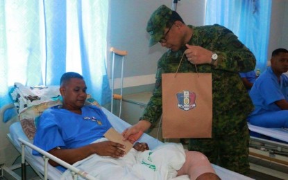<p><strong>HONORING THE WOUNDED.</strong> Maj. Gen. Diosdado Carreon (right), commander of the Army’s 6th Infantry Division and head of Joint Task Force Central (JTFC), pins the wounded personnel medal and hands over a gift and cash assistance to one of the injured infantrymen at the Camp Siongco Station Hospital in Datu Odin Sinsuat, Maguindanao on Monday (March 9, 2020). The wounded personnel formed part of Army troopers pursuing Islamic State-inspired Bangsamoro Islamic Freedom Fighters in the mountains of Maguindanao since March 1, 2020. (<em>Photo courtesy of 6ID)</em></p>