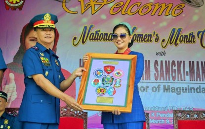 <p>SUPPORT FOR WOMEN. Brig. Gen. Marni C Marcos Jr., regional director for police in the Bangsamoro Autonomous Region in Muslim Mindanao, presents a souvenir to Maguindanao Governor Bai Mariam Sangki-Mangudadatu during the kickoff ceremony for the Women’s Month celebration in police units across the region on Monday (March 9, 2020). The governor pledged PHP1.5 million for the lady police officers’ cooperative in the region<em>. (Photo courtesy of PRO-BARMM)</em></p>