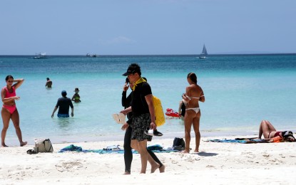 <p><strong>FUN UNDER THE SUN.</strong> Tourists frolic at the beach in Boracay Island during pre-pandemic times. Fully vaccinated tourists from "green list" countries and territories may soon enter the Philippines once the Inter-Agency Task Force issues the guidelines that are expected to come out before the end of the month.<em> (PNA photo by Joey Razon)</em></p>