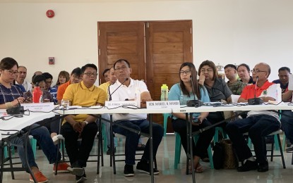 <p><strong>MEETING VS. COVID-19.</strong> Cagayan Governor Manuel Mamba (seated, in white shirt) declares a state of calamity during an emergency meeting of the Provincial Disaster Risk Reduction and Management Council at the Kamaranan Hall of the Provincial Capitol in Tuguegarao City on Saturday (March 14, 2020). A home quarantine will also be imposed on villagers who came from Metro Manila. <em>(PNA photo by Villamor Visaya Jr.)</em></p>