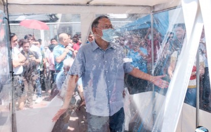 <p><strong>FIGHTING COVID-19.</strong> Marikina City Mayor Marcelino Teodoro presents to the media on Friday (March 13, 2020) the decontamination tents that are part of measures against the spread of Covid-19. The city government has also set up a laboratory testing center for the early detection of Covid-19 cases. <em>(Photo courtesy of Marikina PIO)</em></p>