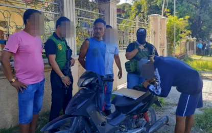 <p><strong>NABBED.</strong> Anti-narcotics operatives account for the items taken from drug suspect Motin Kidap Jr. (handcuffed in blue sleeveless shirt) during a drug buy-bust in Pikit, North Cotabato on Saturday (March 14, 2020). Kidap is a former police officer assigned with Police Regional Office – Bangsamoro Autonomous Region in Muslim Mindanao who went on absence without official leave.<em> (Photo by PDEA-12)</em></p>