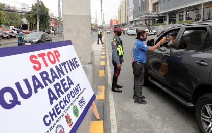 <p><strong>QUARANTINE CHECKPOINT</strong>. A Cainta traffic personnel assisted by a policeman uses a thermal scanner to check the temperature of motorists along Felix Avenue in Cainta, Rizal on Monday (March 16, 2020). President Rodrigo Duterte placed the entire Luzon under enhanced community quarantine to contain the coronavirus disease. <em>(PNA photo by Joey O. Razon)</em></p>