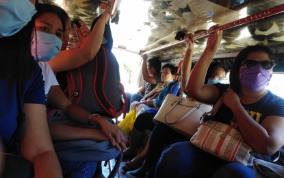 <p><strong>TRANSPORT WOES.</strong> Passengers in a public utility jeepney plying the Iloilo province and Iloilo City route still defy the social distancing measures against the coronavirus disease on Monday (March 16, 2020). The Land Transportation Franchising and Regulatory Board 6 said it will recommend to its central office to offer a one-month moratorium for transport operators as they expect income losses when social distancing will strictly be implemented. <em>(PNA photo by Gail Momblan)</em></p>