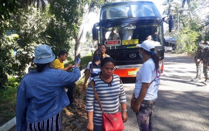 <p><strong>CHECKPOINT.</strong> Personnel of Dapitan City Risk Reduction Management Office, assisted by policemen, establish checkpoints and get temperatures of passengers. Governor Roberto Uy has placed the entire province under “general community quarantine” starting noon on March 17 until April 14. <em>(Photo by Gualberto M. Laput)</em></p>