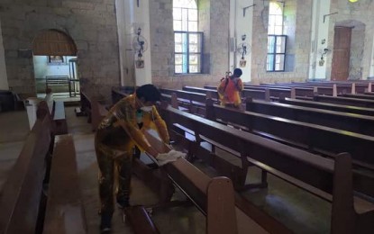 <p><strong>DISINFECT.</strong> Personnel of the municipal disaster risk reduction and management office of Lambunao, Iloilo disinfect pews of the St. Nicholas de Tolentino Parish Church. The Archdiocese of Jaro on Monday (March 16, 2020) advised for the routine sanitation of frequently touched objects inside churches. (Photo by Lambunao MDRRMO)</p>