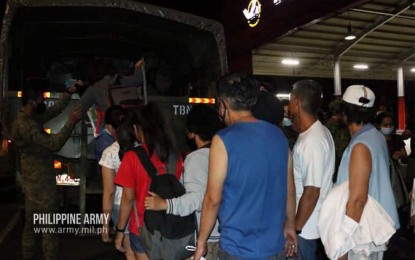 <p><strong>FREE RIDES.</strong> An Army truck ferries quarantine-exempt workers at a pick-up point in Metro Manila on Tuesday (March 17, 2020). Free rides are given to health professionals, food industry personnel and workers from the basic services as public transport is suspended under the Luzon-wide enhanced community quarantine. <em>(Photo courtesy of Army Chief Public Affairs Office)</em></p>