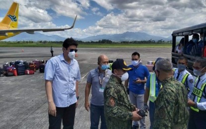 <p><strong>ARRIVAL.</strong> Negros Occidental Provincial Board Member Ryan Gamboa (left) and Provincial Administrator Rayfrando Diaz (2nd from left) facilitate the arrival of 84 Negrenses stranded in Luzon at the Bacolod-Silay Airport in Silay City on Thursday (March 18, 2020). The passengers are now considered persons under monitoring and will undergo a mandatory 14-day quarantine at Mambukal Resort in Murcia town. <em>(Photo courtesy of PIO Negros Occidental)</em></p>