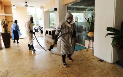 <p><strong>DISINFECTION</strong>. Personnel of the SBMA Fire Department conduct disinfection and decontamination works in one of the hotels inside the Subic Freeport as part of the agency’s effort to counter the spread of the 2019 coronavirus disease (Covid-19). SBMA chairman and administrator Wilma T. Eisma urged all Subic Freeport stakeholders to stay at home and abide by the government’s enhanced community quarantine protocols.<em> (Photo by Ruben Veloria)</em></p>