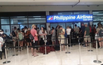 <p><strong>SWEEPER FLIGHTS.</strong> Stranded passengers flock to the Philippine Airlines (PAL) office at the Mactan-Cebu International Airport waiting for the confirmation of their flights. The GMR Megawide Cebu Airport Corporation said on Thursday (March 19, 2020) PAL has flown a sweeper flight to ferry 240 passengers to Manila, while the Philippine Air Force has also flown two rescue or recovery flights. <em>(Photo courtesy of Edward S. Mendez)</em></p>