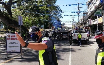 <p><strong>PREVENTING A COMMUNITY SPREAD</strong>. Police conduct regular checkpoints to prevent a spread of the coronavirus disease 2019 (Covid-19) in Negros Oriental. The province has sealed off its borders with neighboring provinces and is under a state of calamity and general community quarantine. <em>(Photo by Judy Flores Partlow)</em></p>