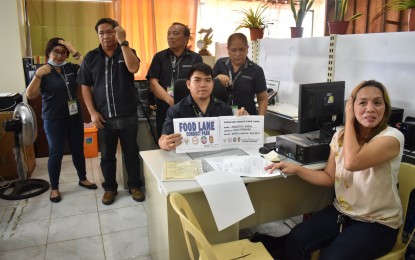 <p><strong>FOOD LANE PASS.</strong> A cargo truck owner receives a food lane vehicle pass card from the Department of Agriculture’s regional office in Tacloban City on Wednesday (March 18, 2020). The office has issued the food lane vehicle pass cards to transporters of essential and perishable goods in Eastern Visayas. <em>(Photo courtesy of DA-8)</em></p>