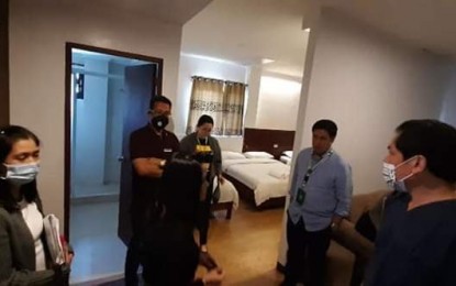 <p><strong>INSPECTION.</strong> Personnel of the Lindi Hotel show one of its 34 rooms to Baguio General Hospital and Medical Center director Dr. Ricardo Runez Jr. (2nd from right in white) and city administrator Bonifacio dela Pena (middle in black) on during an inspection on Friday (March 20, 2020). The owners of the hotel offered the facility to be used as a confinement center for Covid-19 patients under investigation in the city. (Photo courtesy of Baguio PIO)</p>