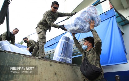 <p><strong>SLEEPING MATS.</strong> Army troops unload camper mats from a military truck at the Lung Center of the Philippines in Quezon City on Friday (March 20, 2020). The mats were donated by Uratex Foam for health workers at the hospital. <em>(Photo courtesy of Army Chief Public Affairs Office)</em></p>