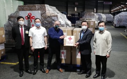 <p><strong>COVID-19 TEST KITS FROM CHINA.</strong> Chinese Ambassador to the Philippines Huang Xilian (2nd from right) turns over a total of 100,000 Covid-19 test kits to Foreign Affairs Secretary Teodoro Locsin Jr. (center) in a ceremony in Parañaque City on Saturday (March 21, 2020). Aside from Covid-19 test kits, the donation also included 10,000 pieces of n95 masks, 100,000 surgical masks, and 10,000 pieces of personal protective equipment. <em>(PNA photo by Joyce Rocamora)</em></p>