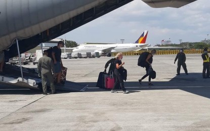 <p><strong>AIDING STRANDED TOURISTS.</strong> Foreign tourists disembark from a C-130 aircraft of the Philippine Air Force at the Ninoy Aquino International Airport Terminal 1 on Thursday (March 19, 2020). The tourists were picked up from the Mactan Air Base in Cebu after they were stranded as local carriers canceled domestic flights in compliance with the enhanced community quarantine in Luzon. <em>(Photo courtesy of Air Force Public Affairs Office)</em></p>