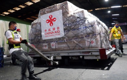<p><strong>CONSOLIDATION.</strong> Workers tow the donation of Covid-19 test kits, face masks, and personal protective equipment turned over by Chinese Ambassador Huang Xilian to Foreign Affairs Secretary Teodoro Locsin Jr. on March 21, 2020. President Rodrigo Duterte has ordered that all donations intended to address coronavirus disease shall be coordinated with and transmitted to the Office of Civil Defense (OCD) for consolidation. <em>(PNA photo by Robert Oswald Alfiler)</em></p>