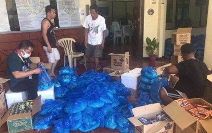 <p><strong>ENSURING FOOD SUPPLY.</strong> Personnel of the city government ready food packs to be distributed to families of daily wage earners, drivers, and indigents who are affected by the month-long enhanced community quarantine that took effect 1 a.m. Friday (March 20, 2020). The quarantine aims to prevent the entry of the 2019 coronavirus disease to Zamboanga City.<em> (Photo courtesy of City Hall Information Office)</em></p>