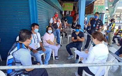 <p><strong>SECURITY MEASURES.</strong> Mayor Eleanor “Joni” Villanueva-Tugna (right) of Bocaue, Bulacan talks to the stall owners in a public market regarding their concerns in community quarantine and criminal elements on Friday (March 20, 2020). Due constraint movement of the public, authorities are anticipating that desperate individuals may turn to looting and even robbing unguarded commercial establishments. <em>(Photo courtesy of Bocaue Municipal Government)</em></p>
