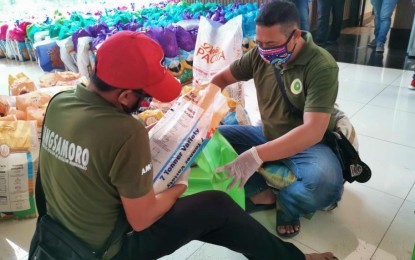 <p><strong>GETTING READY.</strong> Social workers of the Bangsamoro Autonomous Region in Muslim Mindanao on Monday (March 23, 2020) prepare relief goods that would be distributed starting this week to various parts of the region affected by the coronavirus disease 2109 crisis. The region has been placed under general quarantine to address the threats of Covid-19. <em>(Photo by Albashir Saiden – PNA Cotabato)</em></p>