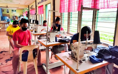<p><strong>SUPPORT TO FRONTLINERS.</strong> Twelve volunteers composed of women and LGBT (lesbian, gay, bisexual, and transgender) in Barangay Esperanza, Carmen, Surigao del Sur, join hands to produce protective facemasks for health workers who are in the frontlines in the fight against the spread of the 2019 coronavirus disease in their town. The volunteers say it is one way of showing their appreciation for health workers who risk their lives every day to contain the coronavirus disease 2019 (Covid-19). <em>(Photo grab from Zairha Sarmiento Pude Facebook Account)</em></p>