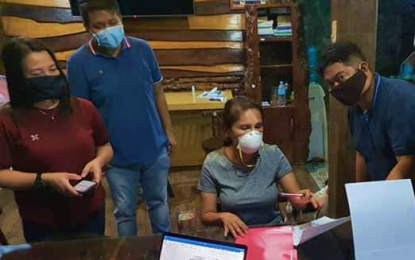 <p><strong>HANDS-ON.</strong> North Cotabato Governor Nancy Catamco (seated) works to ensure the safety of constituents from the threat of the coronavirus diseases 2019. The governor on Monday night (March 23) ordered the provincial social welfare office to also give constituents affected by the Covid-19 crisis locally-produced farm products. <em>(Photo courtesy of North Cotabato PIO)</em></p>