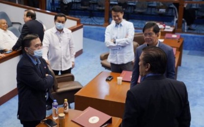 <p><strong>SPECIAL SESSION.</strong> Senator Bong Go (left) chats with fellow lawmakers during a break as the Senate holds a special session to tackle Senate Bill 1418 or the “Bayanihan to Heal As One Act” seeking to boost the government’s capabilities to better address the coronavirus crisis on Monday (March 23, 2020). Go appealed for cooperation during the Luzon-wide enhanced community quarantine. <em>(Contributed photo)</em></p>