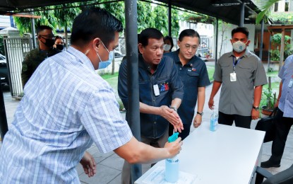 <p><strong>SANITATION FIRST. </strong>President Rodrigo Roa Duterte sanitizes his hands before holding a meeting with some members of his Cabinet to discuss updates on the coronavirus disease (COVID-19) at the Presidential Security Group (PSG) Compound in Malacañang Park on March 24, 2020. The President has signed a new law which gives him special powers for a limited time to help his administration address the Covid-19 pandemic in the country. <em>(Presidential Photo)</em></p>