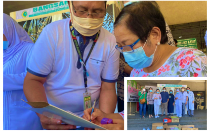 <p><strong>HEAVEN-SENT.</strong> Cotabato Regional and Medical Center chief of hospital, Dr. Helen Yambao (right) signs documents officially accepting augmentation medical supplies and personal protective equipment (inset) given by the Bangsamoro Autonomous Region in Muslim Mindanao in Cotabato City on Wednesday (March 25, 2020). The event came amid another good news after Yambao revealed that Covid-19 Patient 145 at the CRMC has been discharged last week after recovering from the illness following two-week confinement. <em>(Photo by Albashir Saiden – PNA Cotabato)</em></p>