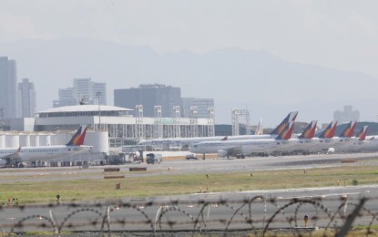 <p><strong>GROUNDED PAL PLANES</strong>. The Ninoy Aquino International Airport (NAIA) Terminals 1 and 2 in Pasay City was turned into parking lots for grounded Philippine Airlines  (PAL) planes due to suspended operations of its international flights starting March 26 until April 14, 2020. The coronavirus disease 2019 (Covid-19) outbreak has pushed commercial planes to stop operations due to the implementation of enhanced community quarantine. (<em>PNA photo by Avito C. Dalan</em>) </p>