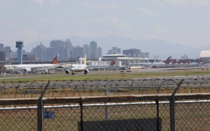 <p><strong>GROUNDED PAL PLANES</strong>. The Ninoy Aquino International Airport (NAIA) Terminals 1 and 2 in Pasay City was turned into parking lots for grounded Philippine Airlines  (PAL) planes due to suspended operations of its international flights starting March 26 until April 14, 2020. The coronavirus disease 2019 (Covid-19) outbreak has pushed commercial planes to stop operations due to the implementation of enhanced community quarantine. (<em>PNA photo by Avito C. Dalan</em>) </p>