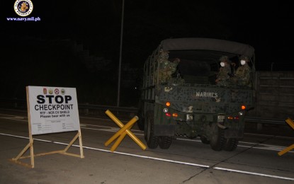 <p><strong>CHECKPOINT.</strong> Marine troops man a community quarantine checkpoint in Luzon on Tuesday (March 24, 2020). The Philippine Navy (PN) has deployed the 12th Marine Battalion to man the various checkpoints in compliance with the Luzon-wide enhanced community quarantine amid the coronavirus disease (Covid-19) outbreak.<em> (Photo courtesy of Naval Public Affairs Office)</em></p>