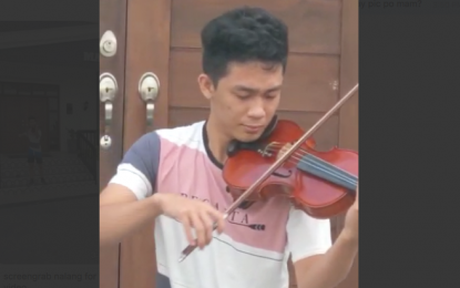 <p><strong>‘PEOPLE NEED THE LORD’.</strong> Nineteen-year-old violinist Orlando Ladia Jr. plays his instrument at The Mansion Hotel in Clark, Pampanga. Ladia offered his performance to everyone affected by the coronavirus crisis after he was stranded in Clark due to travel restrictions. <em>(Screengrab from BCDA)</em></p>