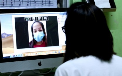 <p><strong>TELEMEDICINE.</strong> A health worker talks to a patient through an online consultation during the launch of Taguig City's 'telemedicine' program on Friday (March 27, 2020). The program attends to the health needs of residents in compliance with the social distancing protocol amid the Luzon-wide enhanced community quarantine due to the coronavirus disease 2019 (Covid-19) pandemic. <em>(Photo courtesy of Taguig PIO)</em></p>