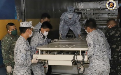 <p><strong>BEDS FOR COVID-19 PATIENTS.</strong> Navy troops unload hospital beds at the Philippine General Hospital in Manila on Friday (March 27, 2020). The beds donated by St. Luke's Medical Center are for Covid-19 patients confined at the hospital. <em>(Photo courtesy of Naval Public Affairs Office)</em></p>