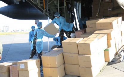 <p><strong>ESSENTIAL EQUIPMENT.</strong> Philippine Air Force personnel unload medical equipment and supplies from its C-130 plane which arrived in two batches on March 21 and 28, 2020 at the Villamor Air Base, Pasay City. The donations were given by a Filipino-Chinese community, a private company, and a person who all requested anonymity. <em>(Photo courtesy of AFP Public Affairs Office)</em></p>