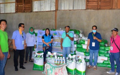 <p><strong>SEEDS FOR FARMERS.</strong> File photo of personnel of the Ministry of Agriculture Fisheries and Agrarian Reform–Bangsamoro Autonomous Region in Muslim handing over hybrid rice seeds to farmers of Datu Abdullah Sangki town in Maguindanao on March 26, 2020. The agency has scheduled the distribution of rice and vegetable seeds to other parts of the region to cushion the impact of the crisis brought about by the coronavirus disease 2019. <em>(Photo courtesy of MAFAR-BARMM)</em></p>