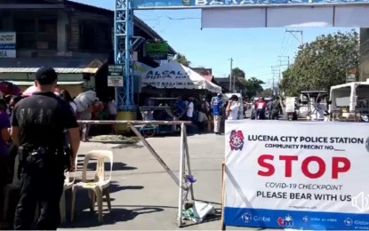 <p><strong>LOCKDOWN</strong>. Police personnel man a checkpoint in Barangay Cotta in Lucena City, which was placed under a total lockdown on Thursday (April 2, 2020). The lockdown was imposed by the city government after one of the villagers tested positive of Covid-19.<em> (Photo courtesy of Ylou Dagos)</em></p>