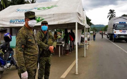 <p><strong>SECURING FRONT-LINERS.</strong> The Army's 402nd brigade commander, Brig. Gen. Maurito L. Licudine (left), inspects quarantine checkpoints in different points in Caraga Region. The Army has provided more than 500 soldiers to augment the security of front-liners in the fight against coronavirus disease in the region. <em>(Photo courtesy of the Army's 402nd Brigade)</em></p>