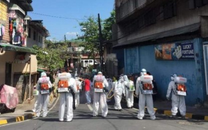 <p>Disinfection work in a street in San Juan City. (File<em> photo)</em></p>