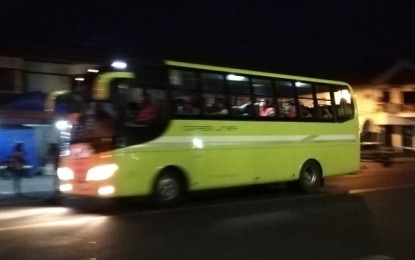 <p><strong>BUS STOP.</strong> A Ceres Liner bus picks up passengers at the Bacolod public plaza bus stop on Wednesday night (April 1, 2020). Operator Vallacar Transit, Inc. provided 21 buses to the city government to ferry medical personnel and workers of essential services during the enhanced community quarantine from March 30 to April 14. <em>(PNA photo by Nanette L. Guadalquiver)</em></p>
