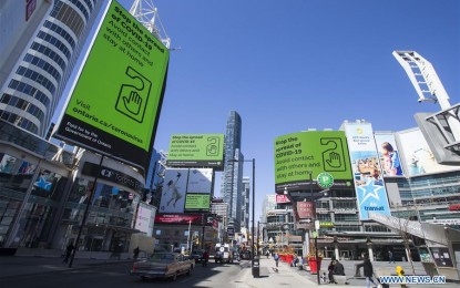 <p>Commercial screens display the Ontario government's messages on Covid-19 at the Yonge-Dundas Square in Toronto, Canada, on April 2, 2020. The number of confirmed Covid-19 cases worldwide has risen above 1 million, according to the new tally from Johns Hopkins University on Thursday afternoon. <em>(Photo by Zou Zheng/Xinhua)</em></p>