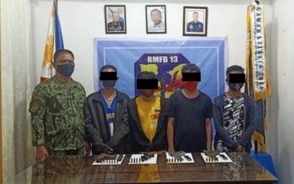 <p><strong>HUNGRY AND TIRED. </strong> Four members of the communist New People’s Army surrender to the Regional Mobile Force Battalion of the Police Regional Office-Caraga on Friday (April 3) at Camp Col. Rafael C. Rodriguez in Butuan City. The four rebels say hunger and fatigue drove them to go back to the fold of the law. <em>(Photo courtesy of PRO-13 Information Office)</em></p>